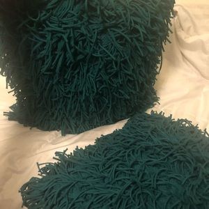 Two teal green couch pillows. Fun shag texture.
